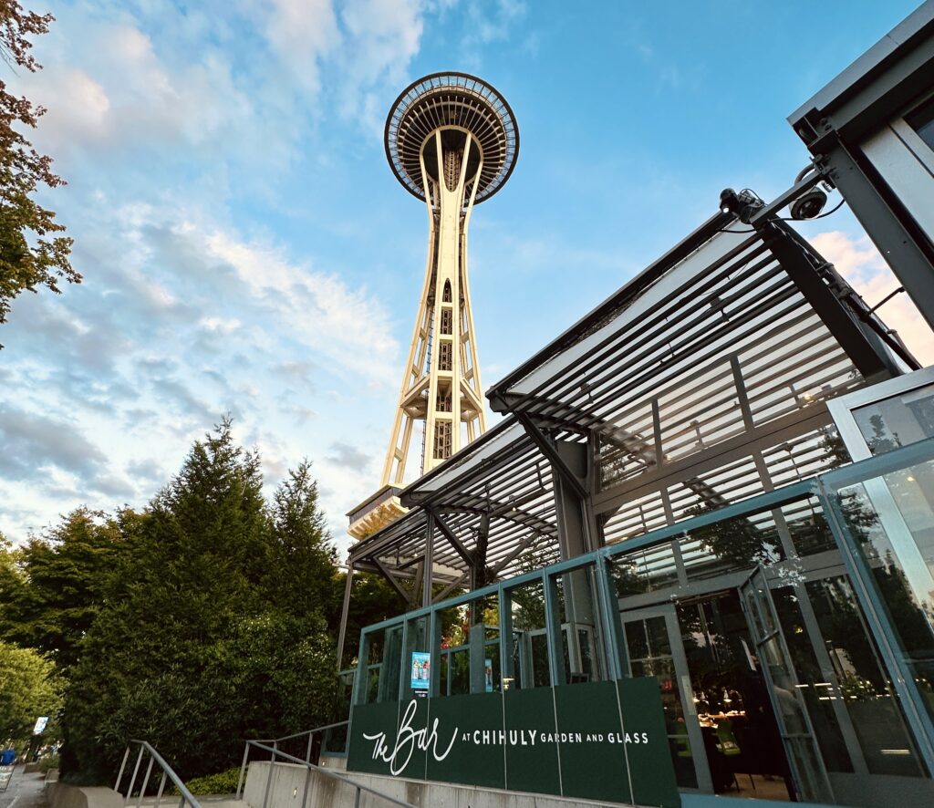 the space needle in seattle outside of the bar at chihuly garden and glass